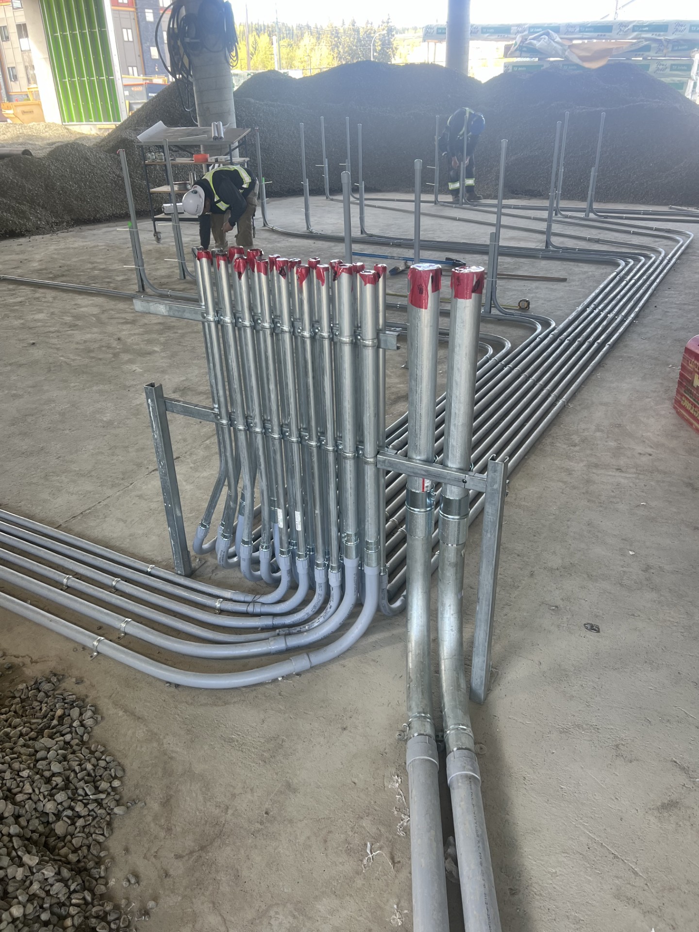 NuWave crew installing conduit in a concrete raft slab