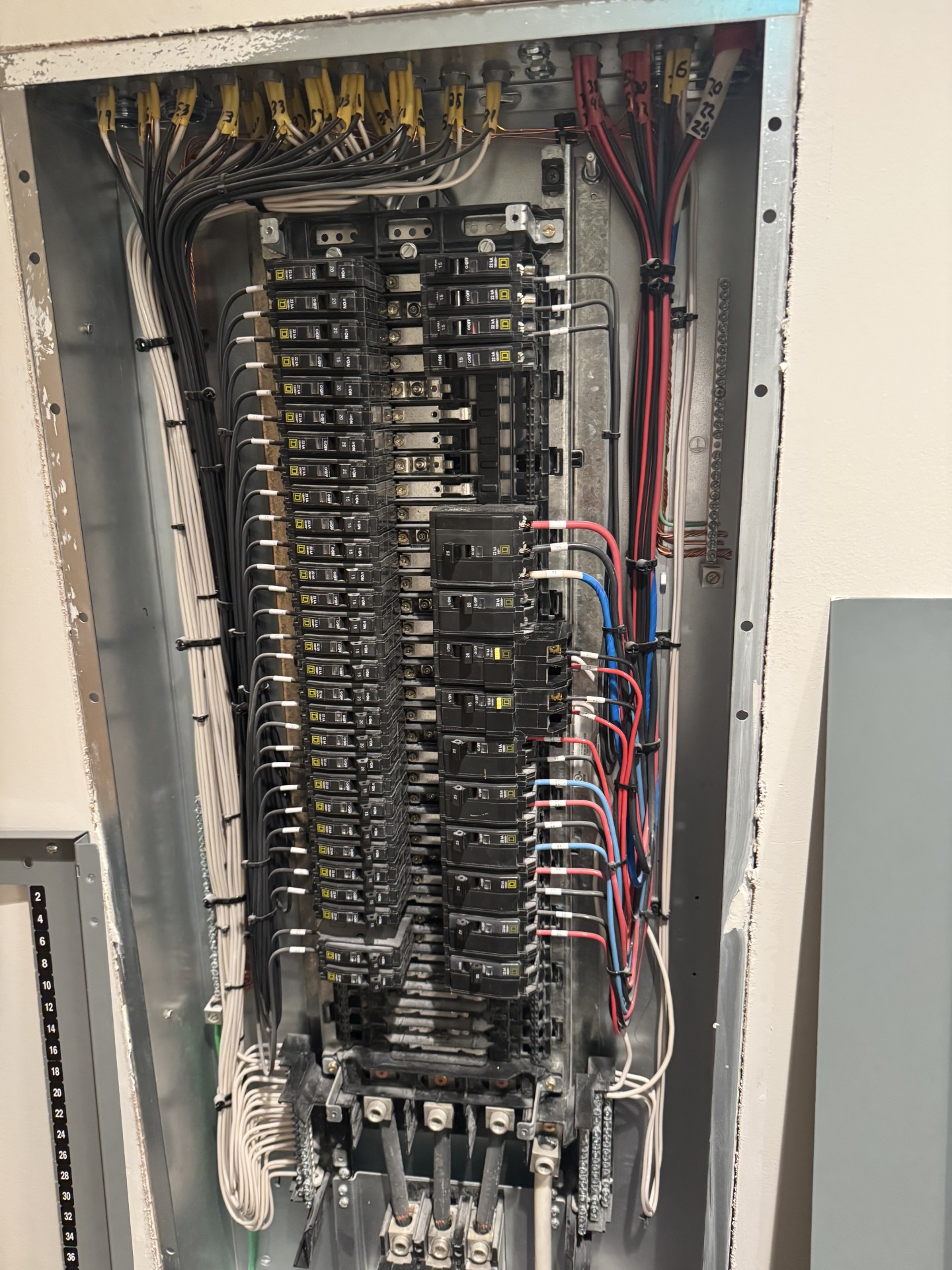 NuWave electrician working on a commercial panel board